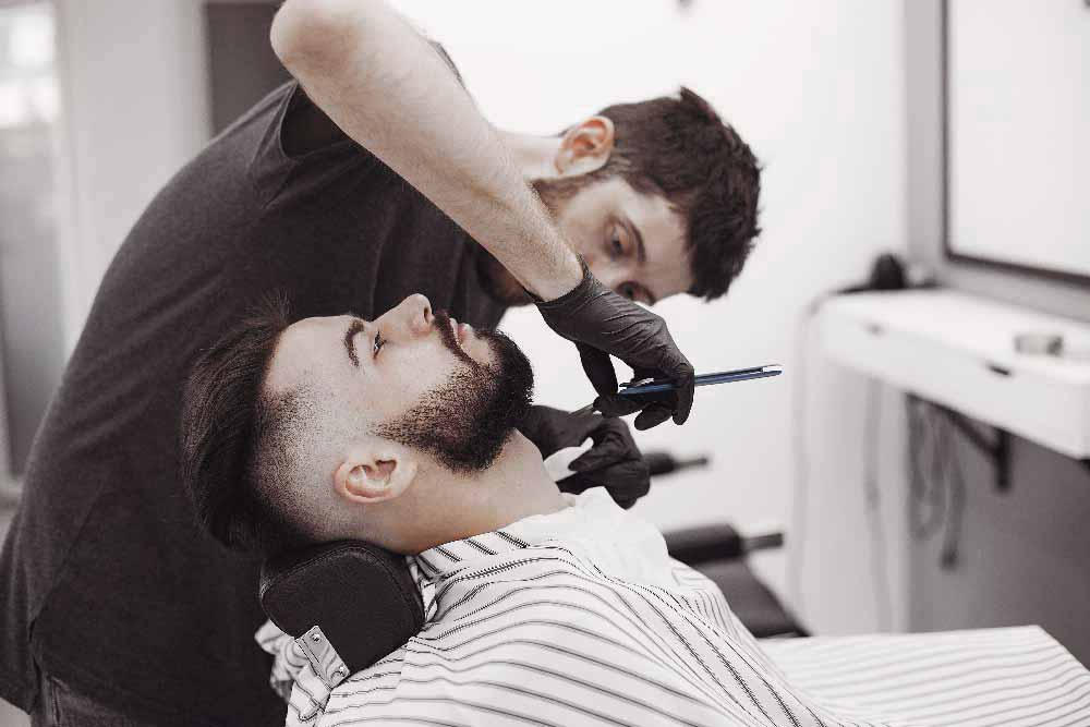 stylish-man-sitting-in-a-barbershop-U4YAVRL.jpg