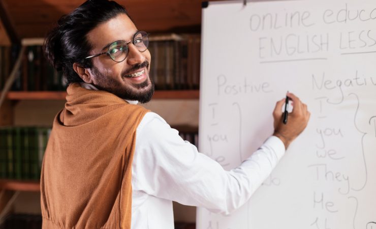 Happy Indian Teacher Man Teaching English Language Online At Home